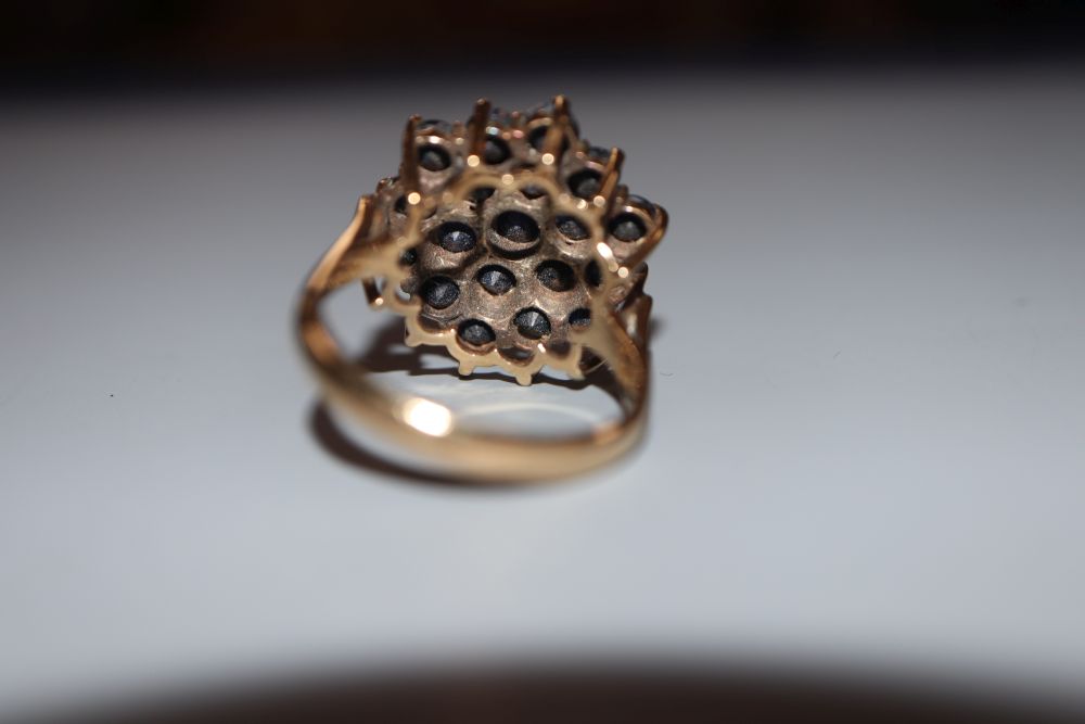 A modern 9ct gold and sapphire cluster dress ring, size M, gross 5.2 grams.
